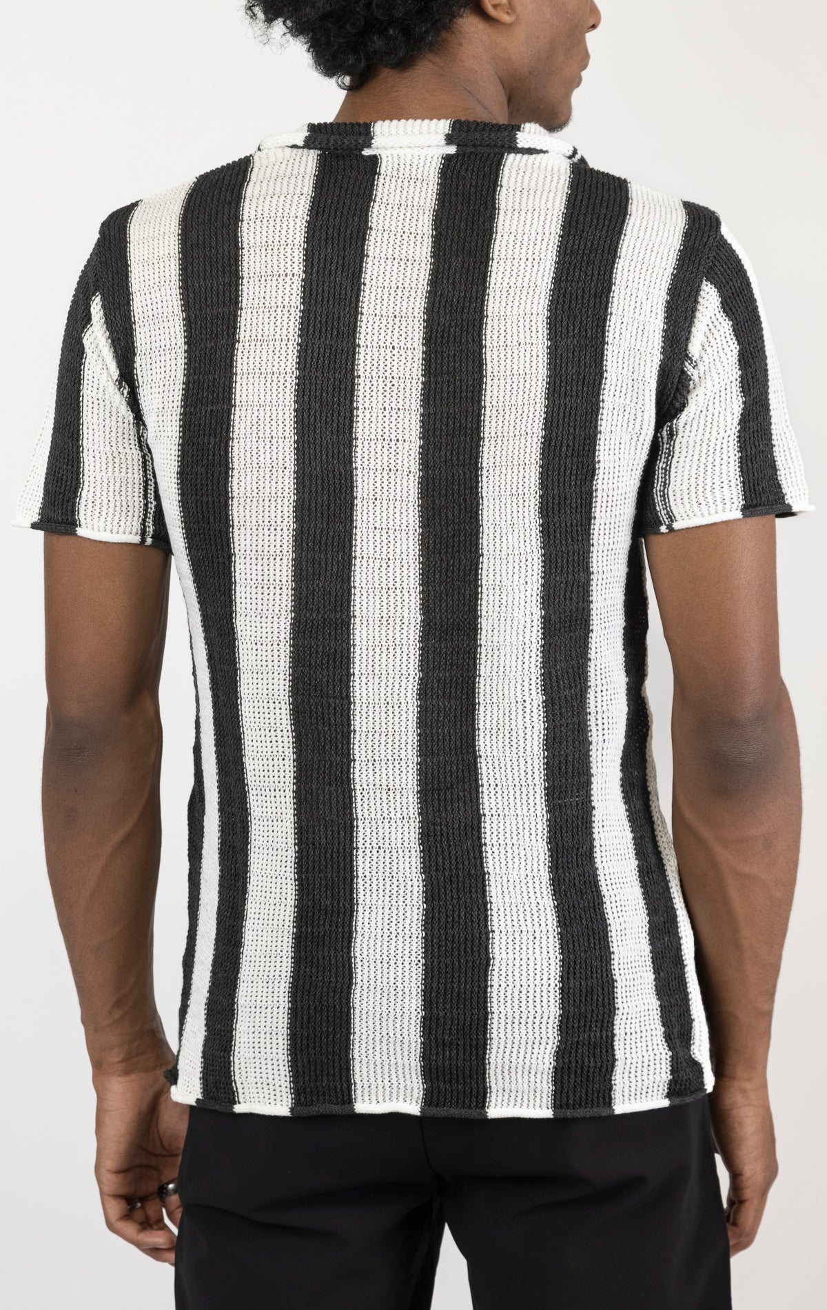Men's openwork knit polo tee. The polo tee is made from a high-quality openwork knit fabric (50% cotton, 50% acrylic) and features a tailored fit, a classic polo collar with buttons, and short sleeves with intricate openwork detailing throughout the fabric.